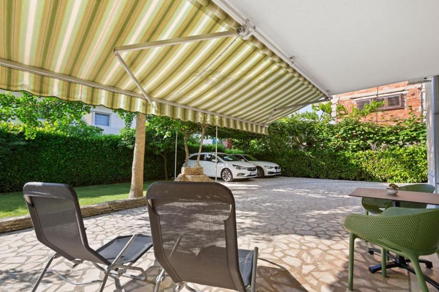 The courtyard with sun loungers and a table in the shade