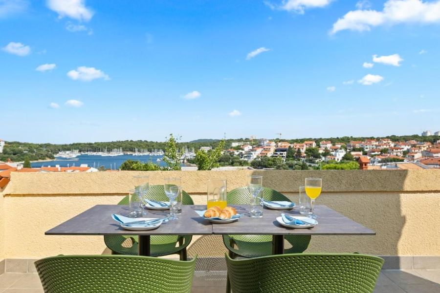 The roof terrace of the two-bedroom apartment, with a view over the bay